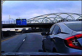 Fleeing Driver Weaves Through Highway Traffic With Police Behind