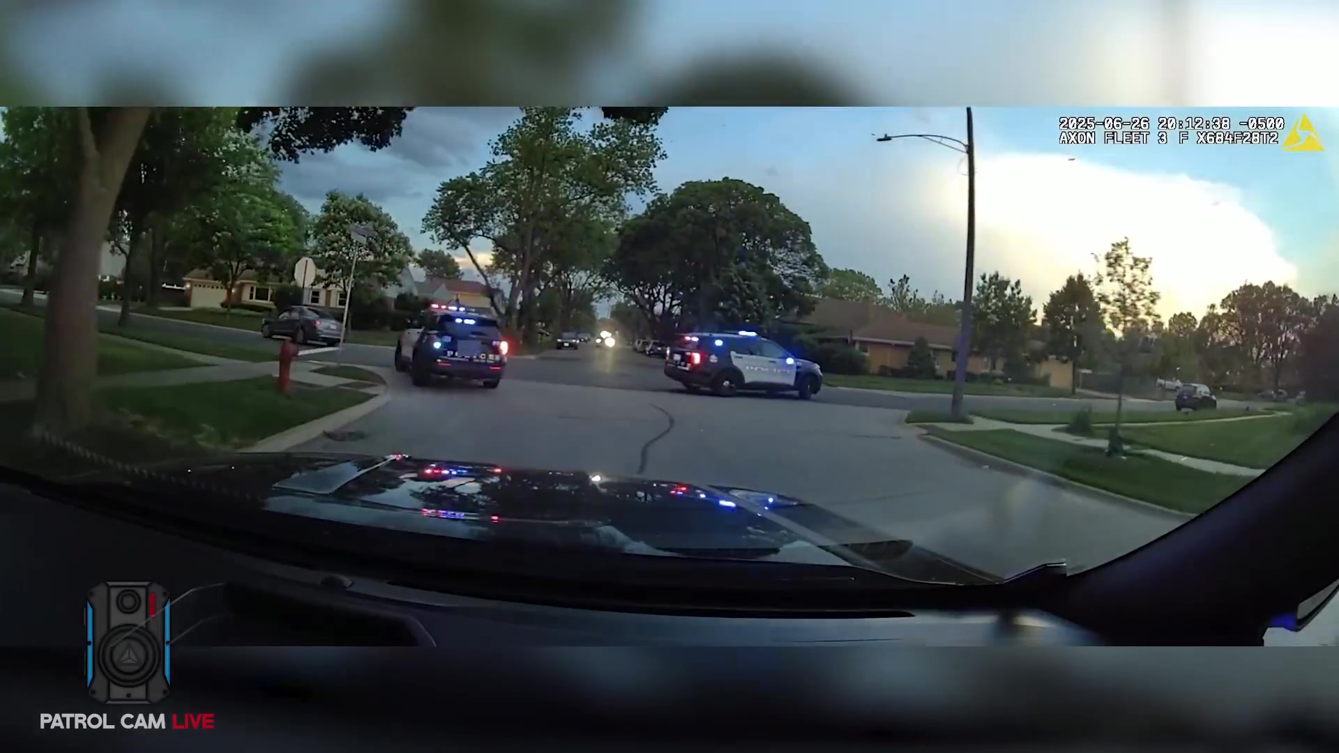 Real frame from the supplied video showing police vehicles during the pursuit and containment