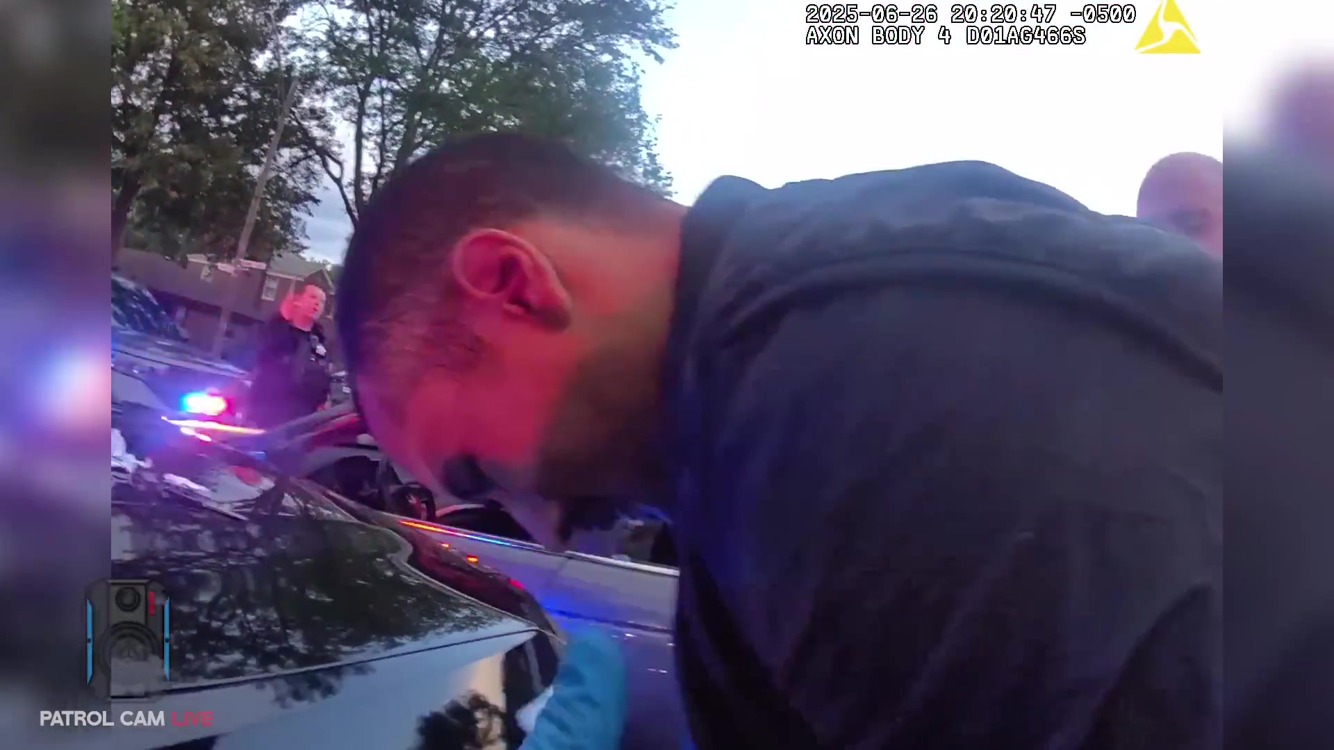 Real frame from the supplied body-camera video showing officers surrounding the stopped vehicle