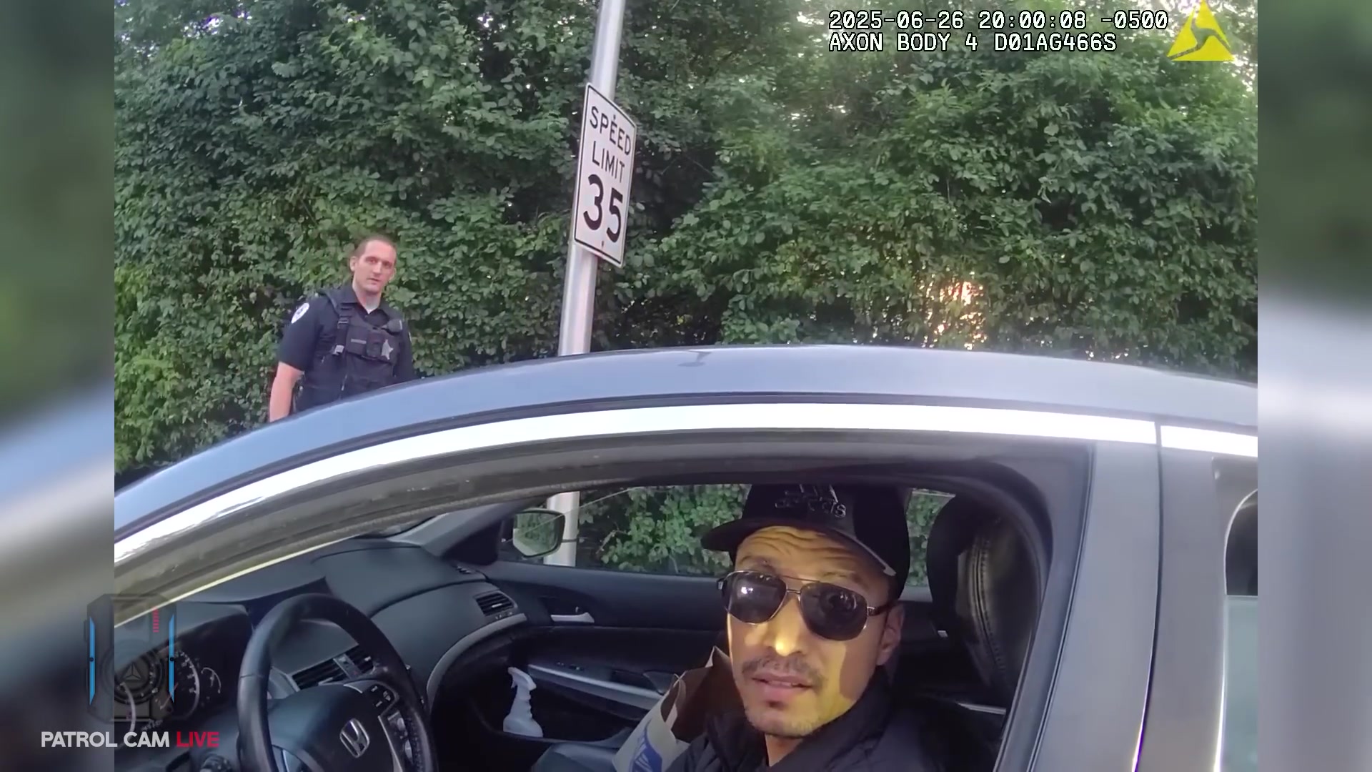 Real frame from the supplied body-camera video showing the driver during the police stop