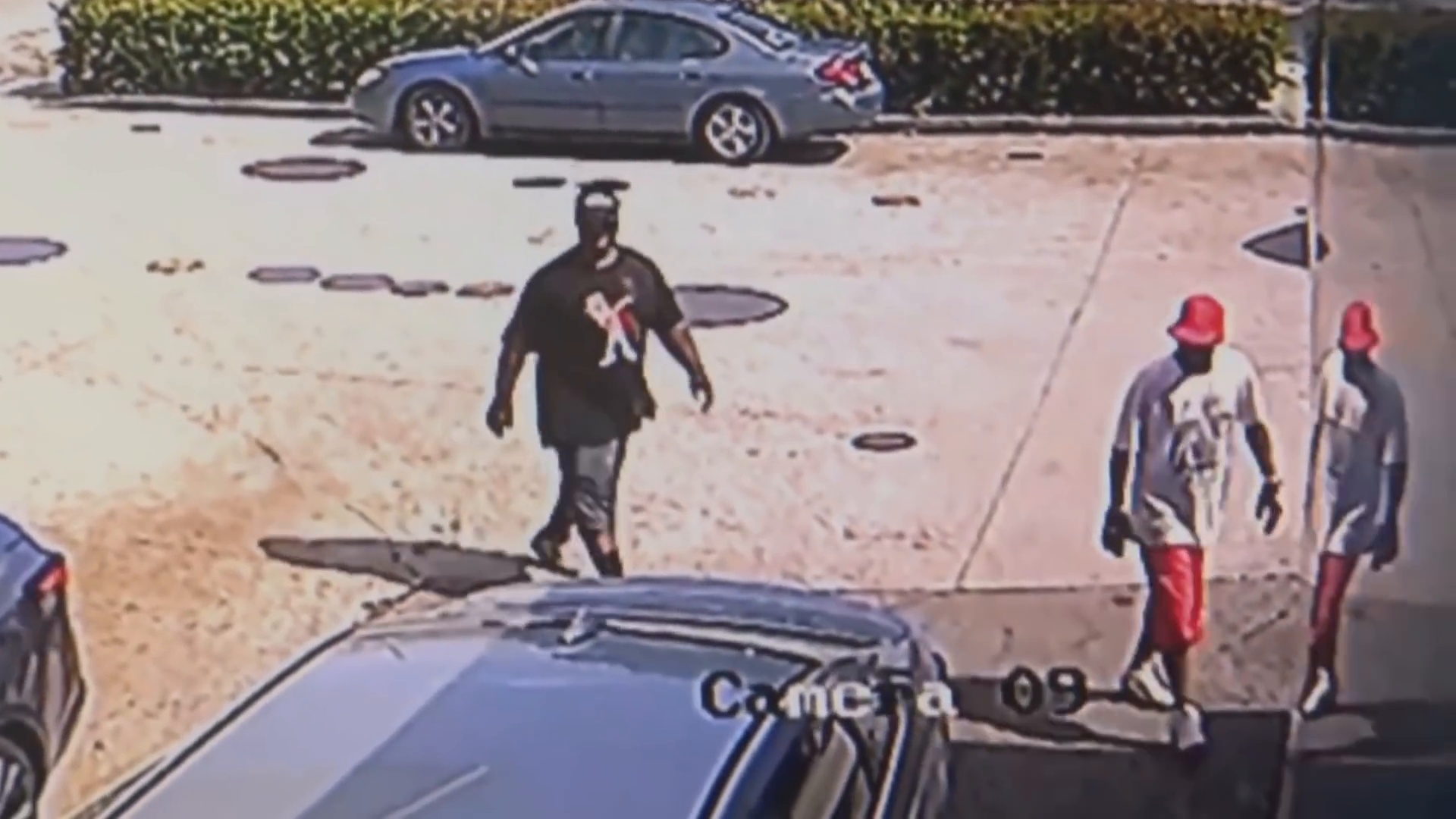 Real surveillance frame from the supplied video showing the two men approaching the Valero gas station