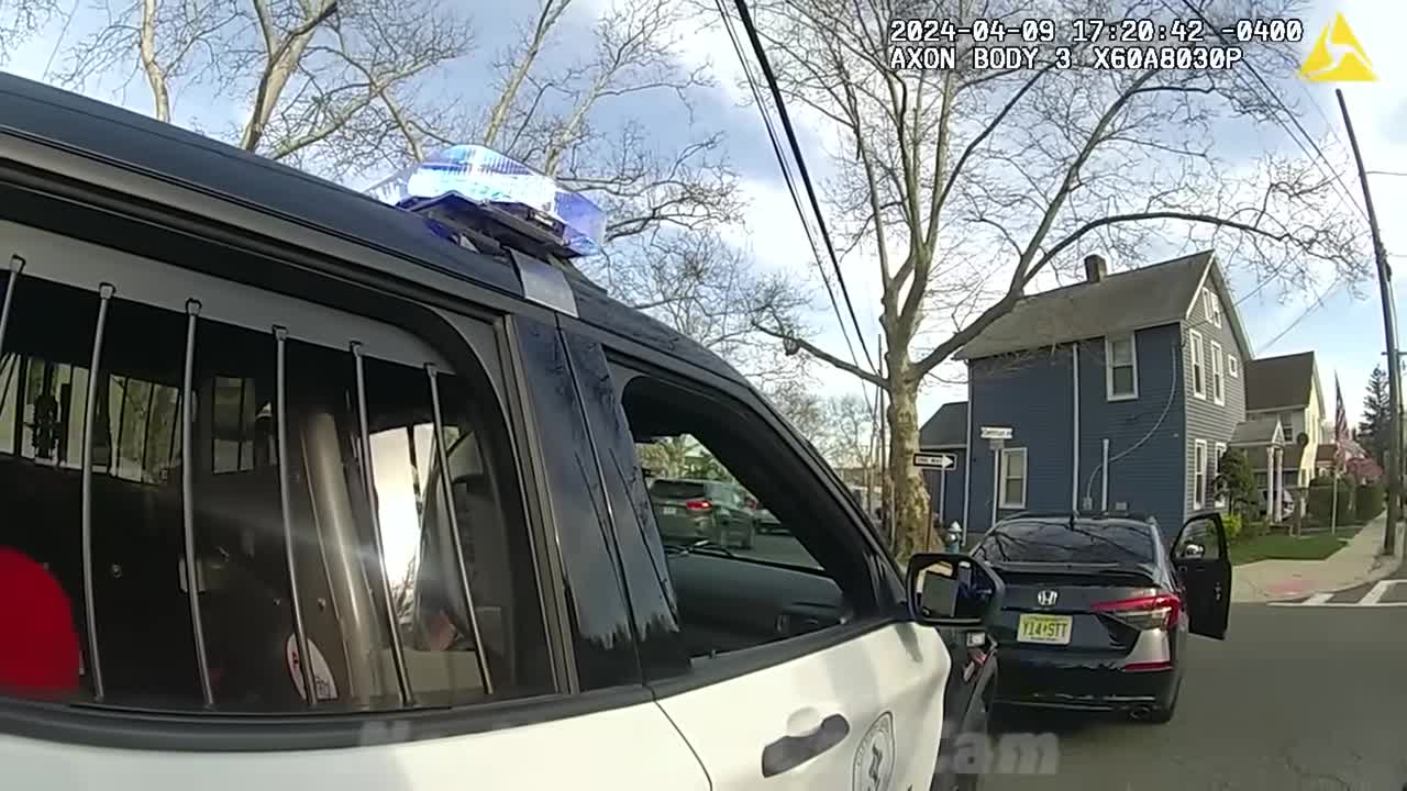 Real frame from the supplied body-camera footage showing the Honda Civic beside a marked police vehicle later in the encounter