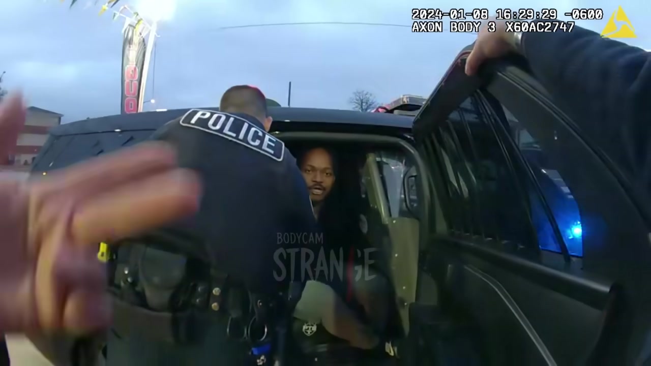 Real frame from the supplied footage showing officers during the later stage of the encounter