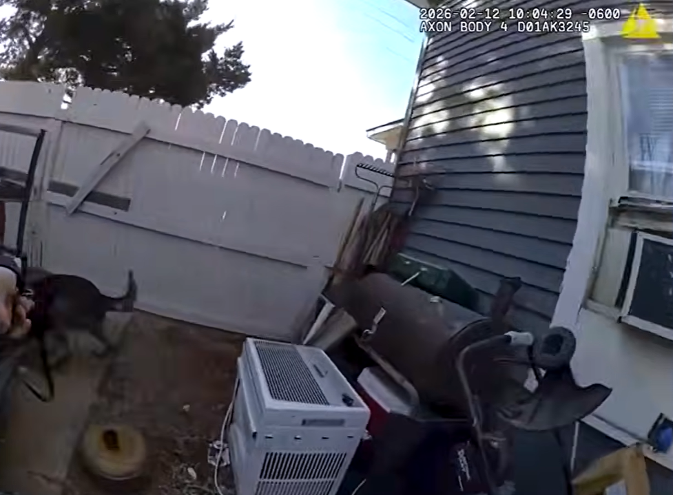 Real February 12, 2026 Oklahoma City Police body-camera frame showing K9 Gunner searching beside a residence