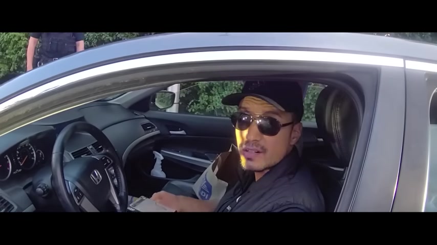 Real frame from the supplied footage showing the Acura driver speaking with police during the traffic stop
