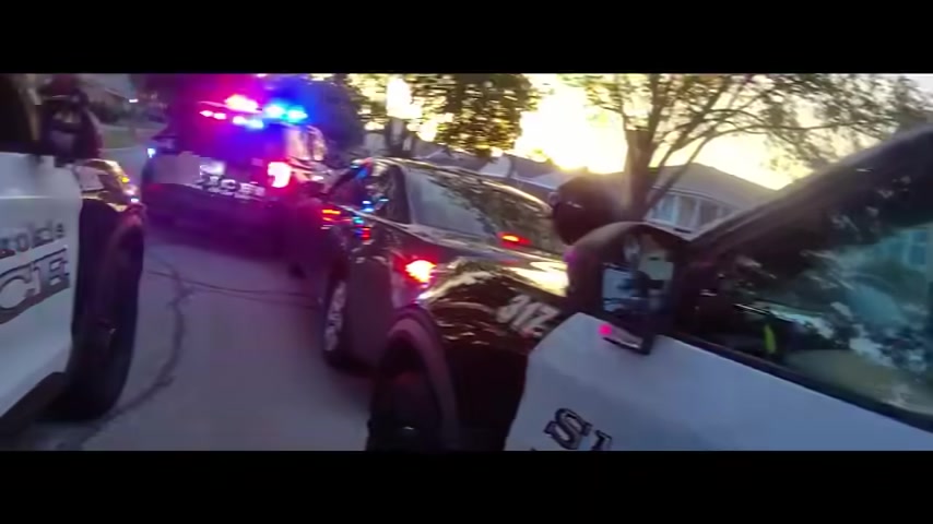 Real frame from the supplied footage showing multiple police vehicles around the Acura during the later stage of the encounter