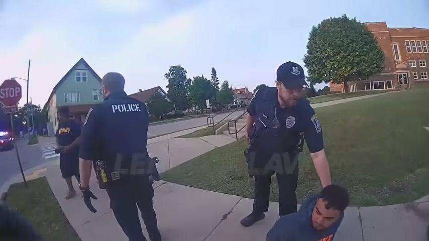 Real frame from the supplied police video showing officers after the arrests