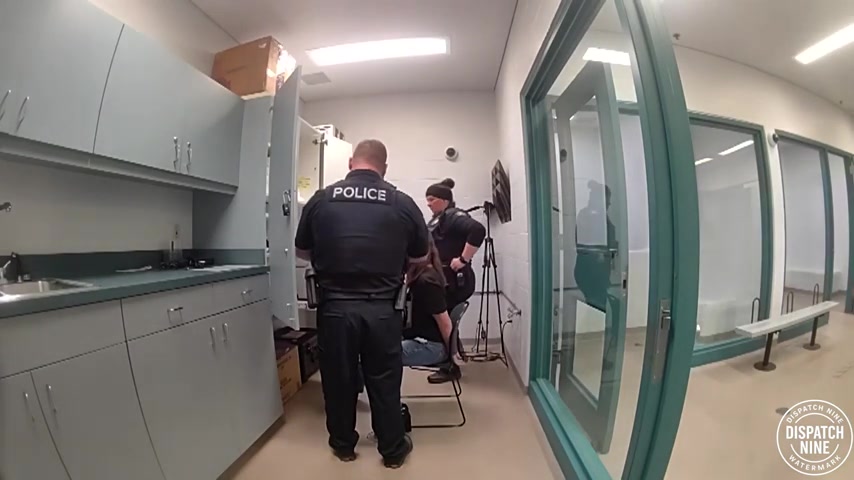 Real frame from the supplied Ormond Beach police footage showing Shanna McRee seated during DUI processing
