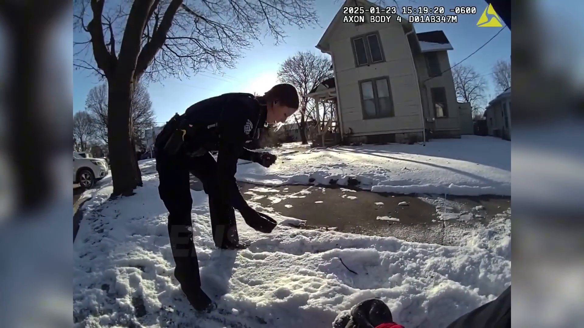 Uncropped frame from the supplied footage showing the officer after the struggle in the snow