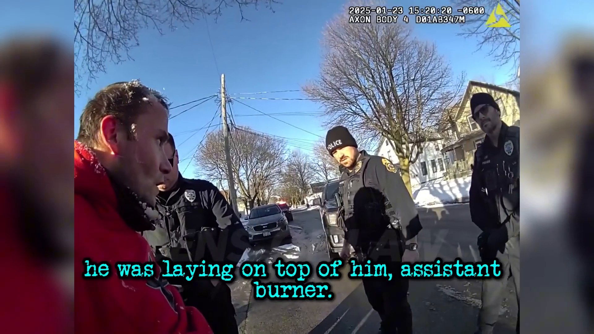 Uncropped frame from the supplied footage showing responding officers with the detained man