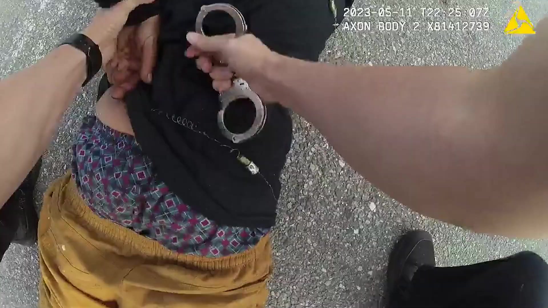 Bodycam frame showing officers handcuffing Daniel Forrest after the Taser deployment