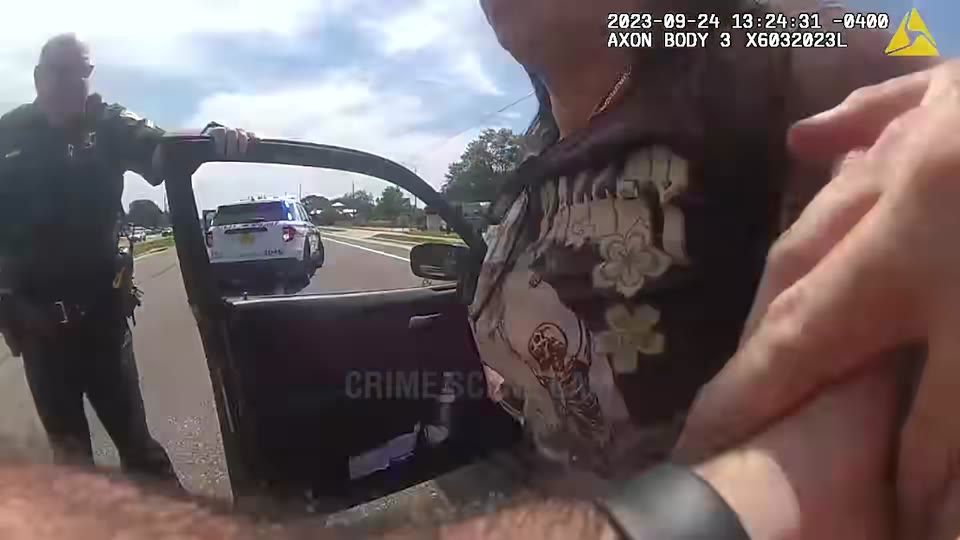 Body-camera view as officers escort the woman to a patrol vehicle