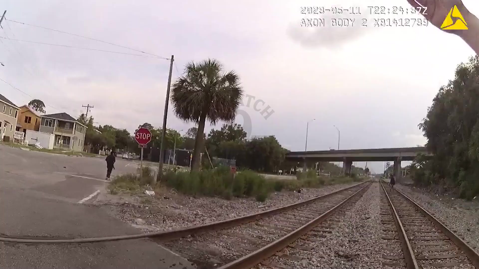 Bodycam frame showing the railroad corridor during the May 11, 2023 Jacksonville pursuit