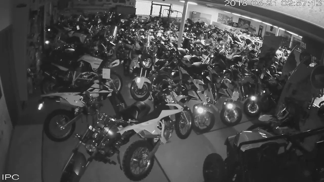 Suspect moving among motorcycles inside Southeast Sales Powersports