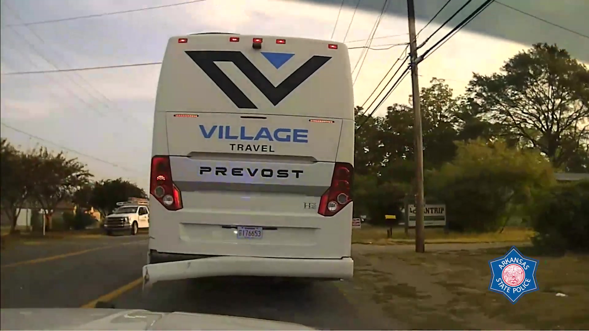 Arkansas State Police dashcam frame showing the stolen Village Travel Prevost bus