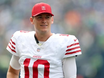 49ers Make Latest Move Regarding Mac Jones’ Future as GM John Lynch Receives More Than 3 Calls and $30 Million Trade Requests