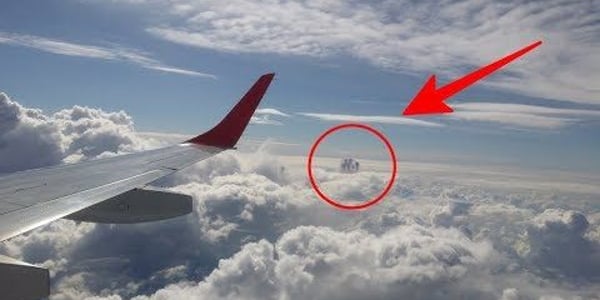 Passengers Aboard Plane Stunned as They Spot Mysterious Object, Suspected to Be a UFO, Amongst the Clouds (VIDEO)
