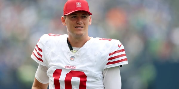 49ers Make Latest Move Regarding Mac Jones’ Future as GM John Lynch Receives More Than 3 Calls and $30 Million Trade Requests